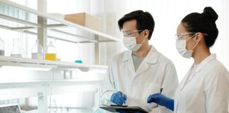 Naukowcy w laboratorium w maskach analizują dane do modeli machine learning